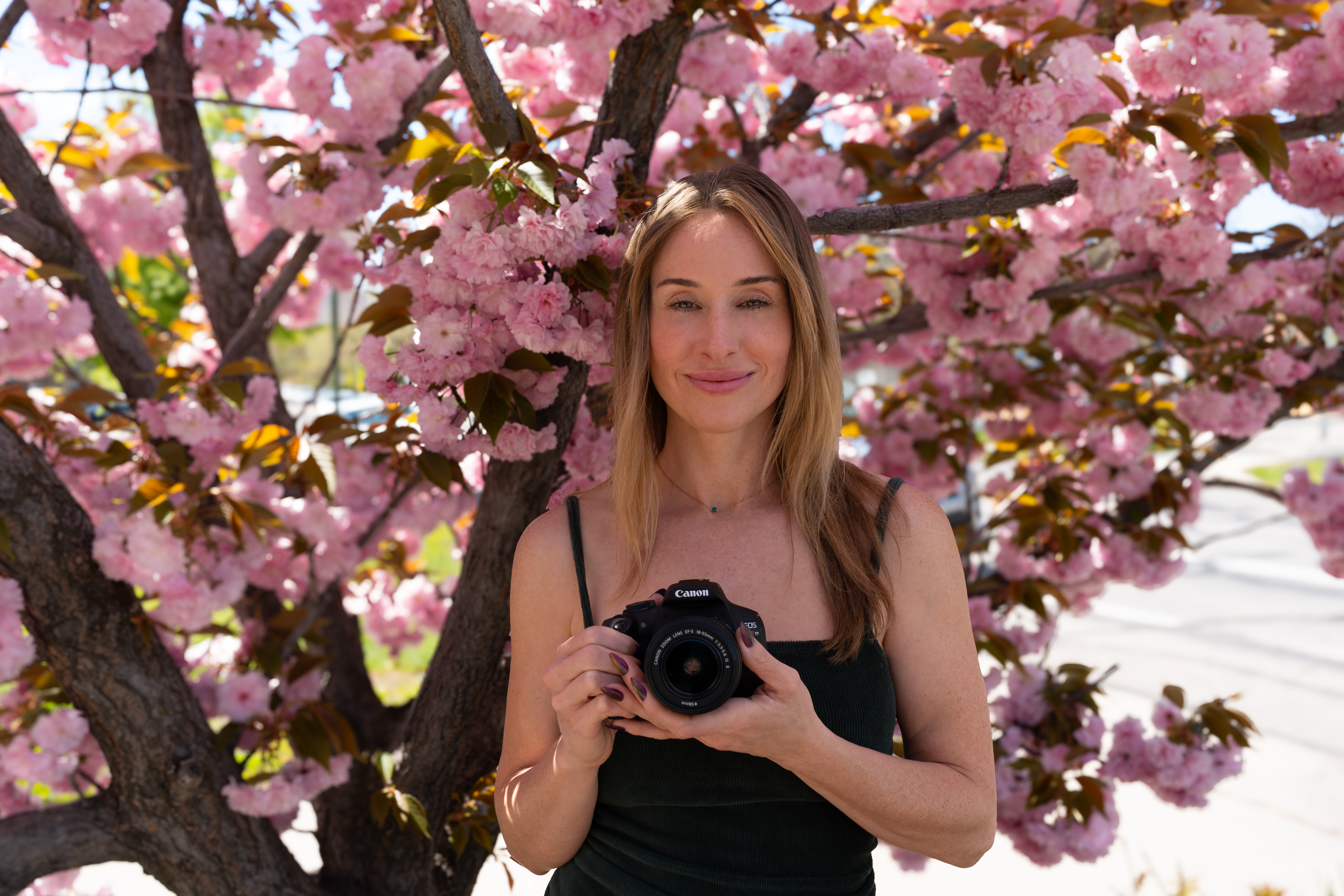 Meg with camera in cherry blossoms